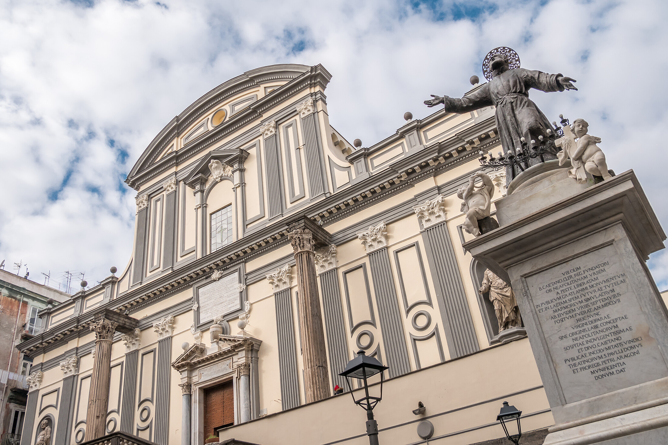 View of the facade of Basilica di San Paolo Maggiore (San Paolo Maggiore Church) on Via dei Tribunali (Tribunali Street) in Naples, Campania, Italy. San Gaetano square (Piazza San Gaetano)