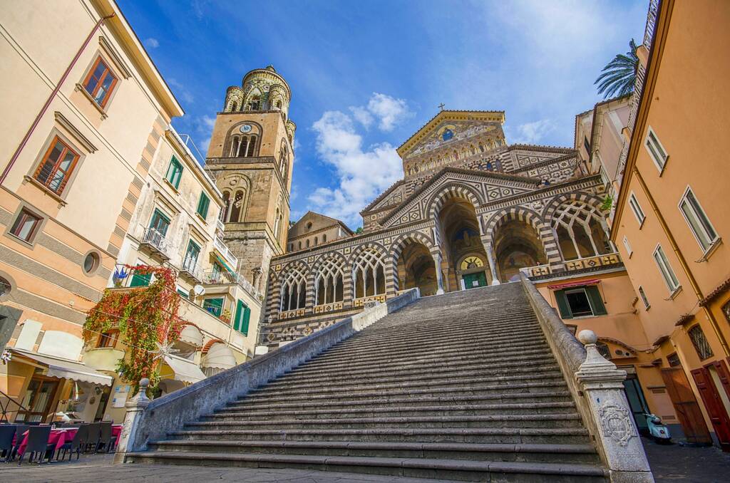 The Amalfi Cathedral bell tower in Amalfi, Italy. The stairs and central facade, dedicated to the Apostle Saint Andrew, Roman Catholic church in the Piazza del Duomo
