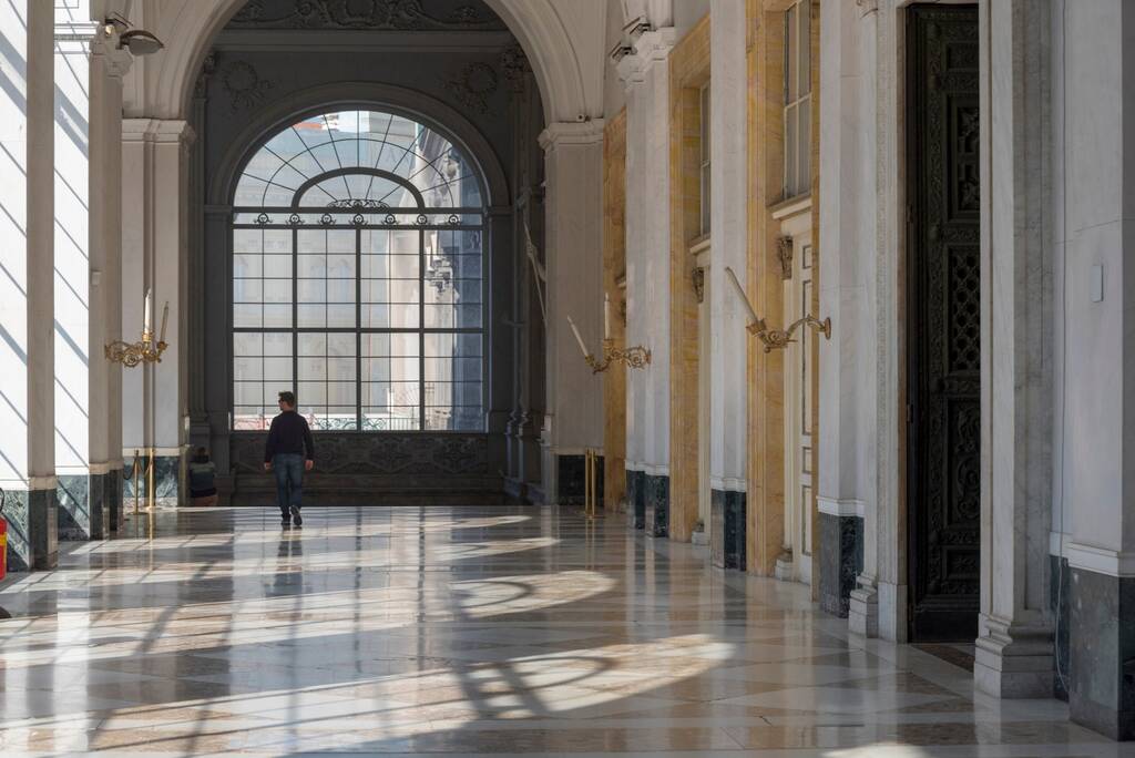 Royal Palace of Naples, Italy, October 2018. Beautiful white interior of large corridors. Illuminated by the natural light of this Baroque and neoclassical Palace
