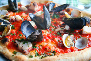 Italian pizza with seafood - octopus, calamary, mussels and clams