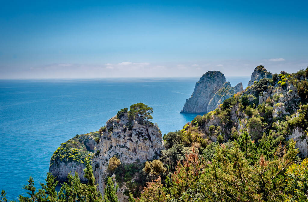View of famous Faraglioni Rocks from Pizzolungo trail   in  Capri island, Italy.