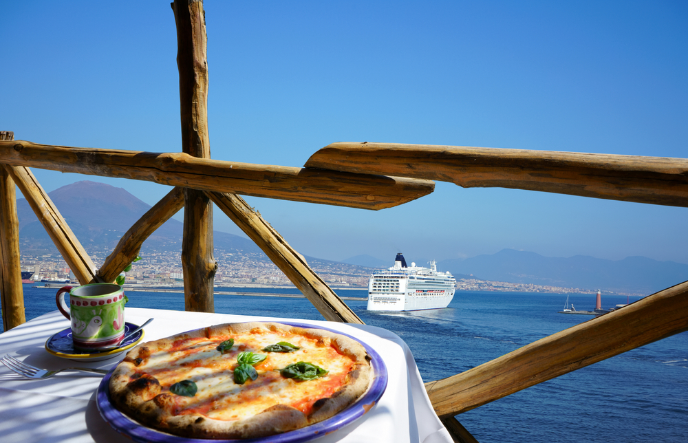                                         Italian pizza Margarita served on terrace overlooking to volcano Vesuvius and Napoli port, Italy