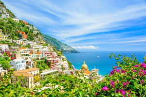 beautiful view on Positano on Amalfi coast with blurred flowers on foreground, Campania, Italy. focus on background