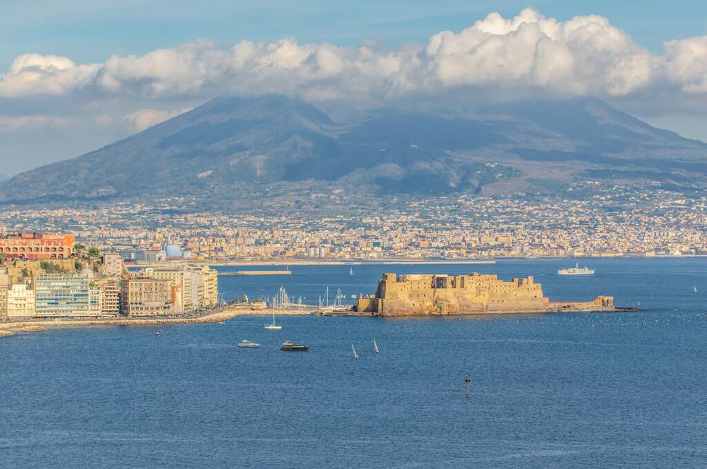 Naples, Italy - built during the 15th century, Castel dell'Ovo (Egg Castle) is a seaside castle located in the Gulf of Naples. Here the fortress with Mount Vesuvius in the background
