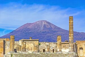 Temple ruins at the ancient Roman city of Pompeii, Italy. which was destroyed by mount Vesuvius (seen in background) volcanic eruption in AD 79