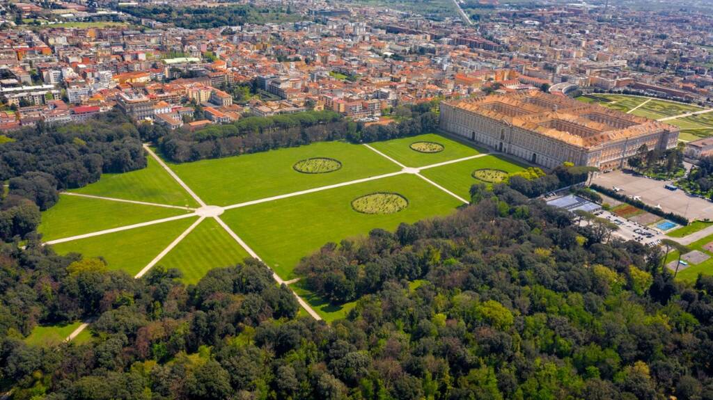 Aerial view of the Royal Palace of Caserta also known as Reggia di Caserta. It is a former royal residence with large gardens in Caserta, near Naples, Italy. The historic center of the city is nearby.